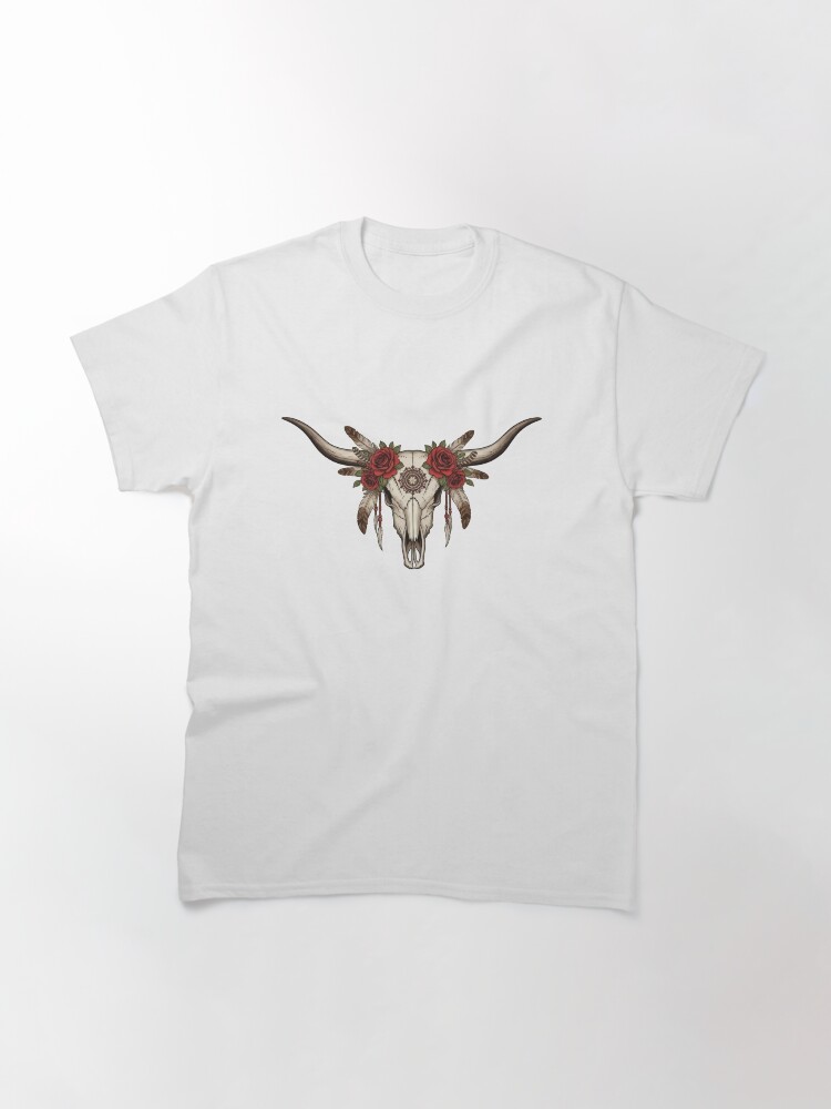 “Longhorn cow skull with feathers and roses in boho western style on rustic t-shirt – country girl aesthetic shirt design”