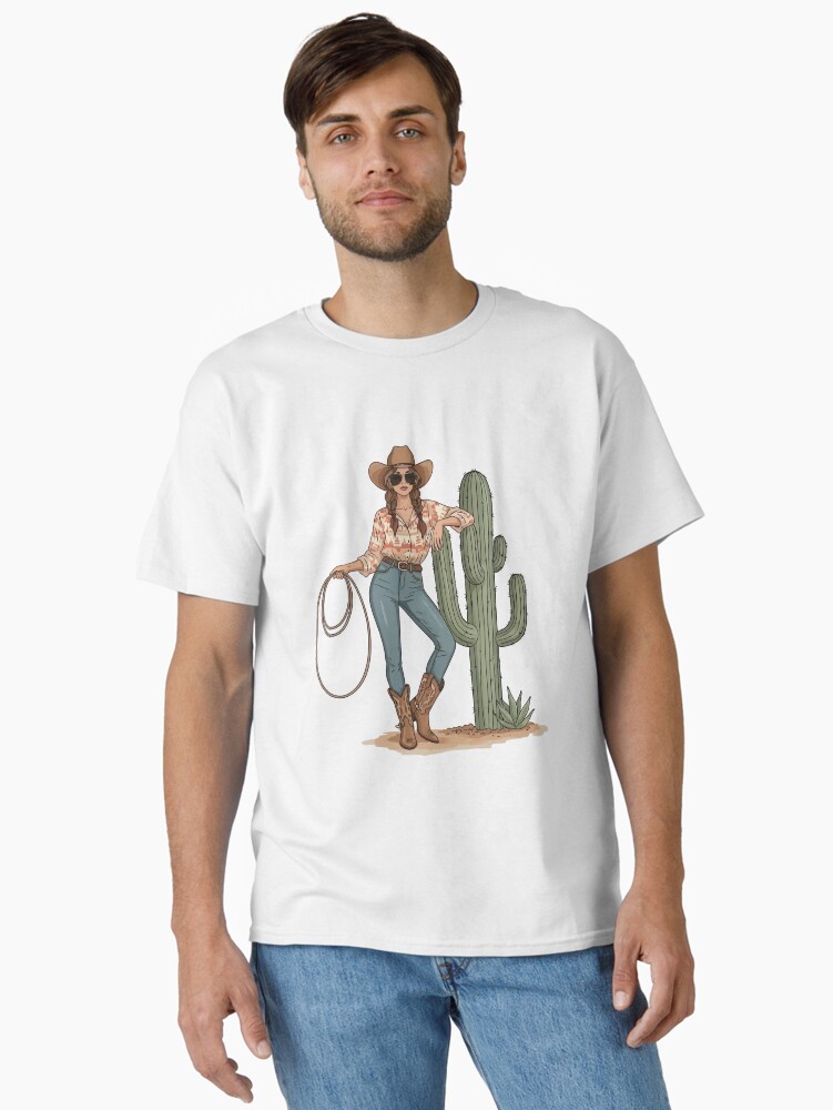 “Boho cowgirl t-shirt with cactus, hat, boots, and floral western design – feminine rodeo style”