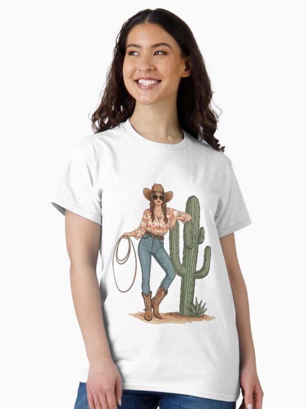“Boho cowgirl t-shirt with cactus, hat, boots, and floral western design – feminine rodeo style”