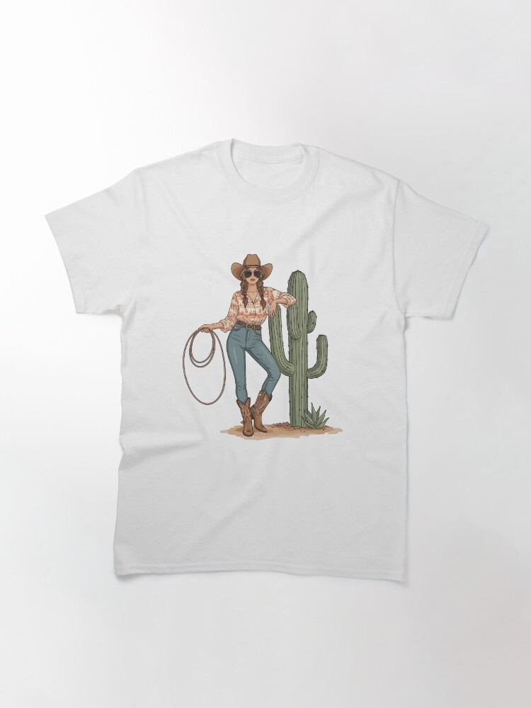 “Boho cowgirl t-shirt with cactus, hat, boots, and floral western design – feminine rodeo style”
